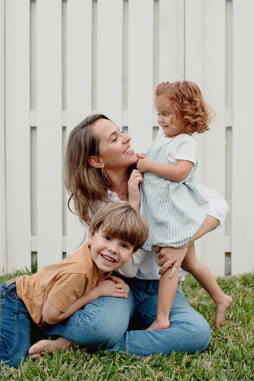 Family Portraits Fort Lauderdale: Portrait of Paula with her two children sitting on the grass in Fort Lauderdale.