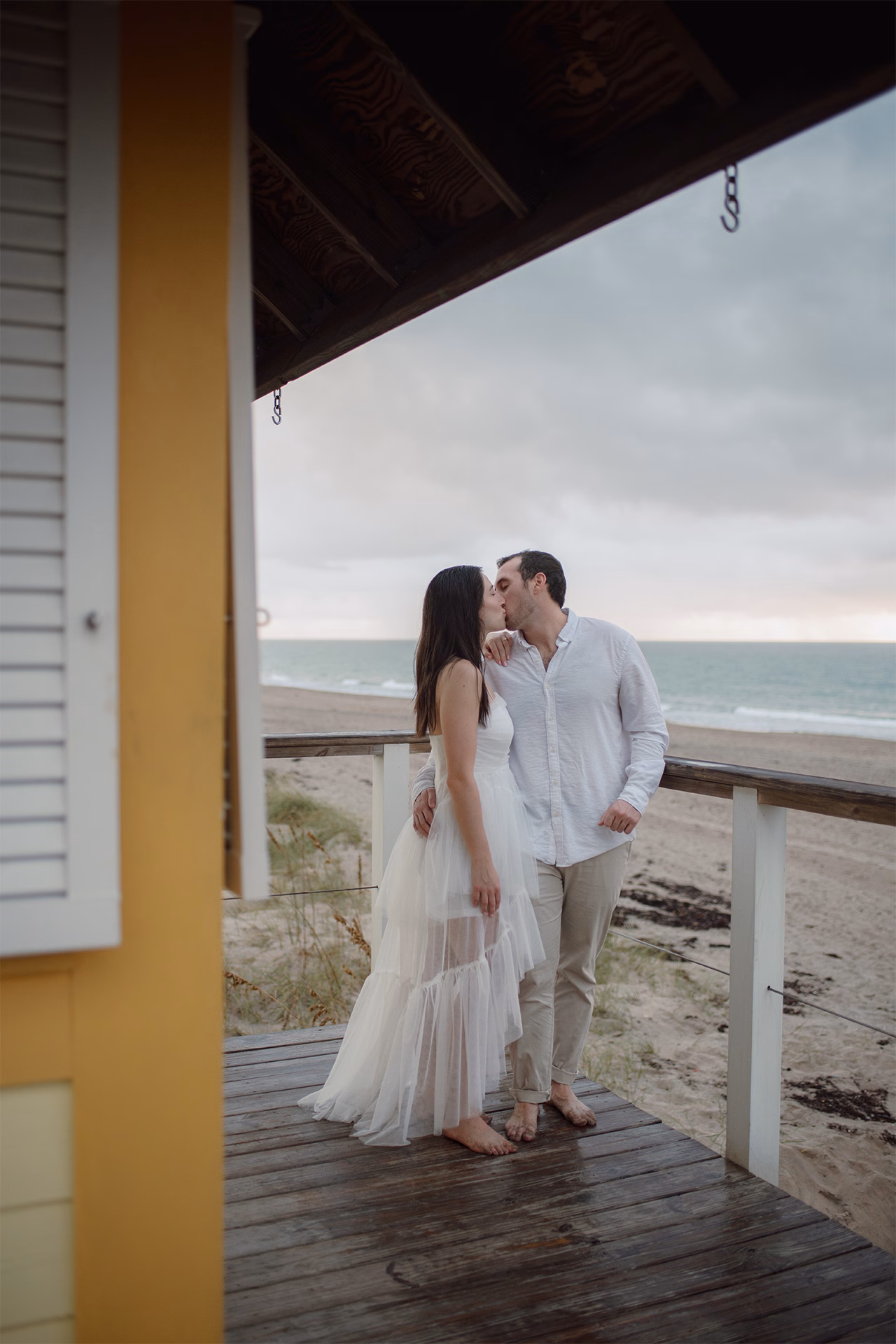 Zoom out of portrait kissing in the rain