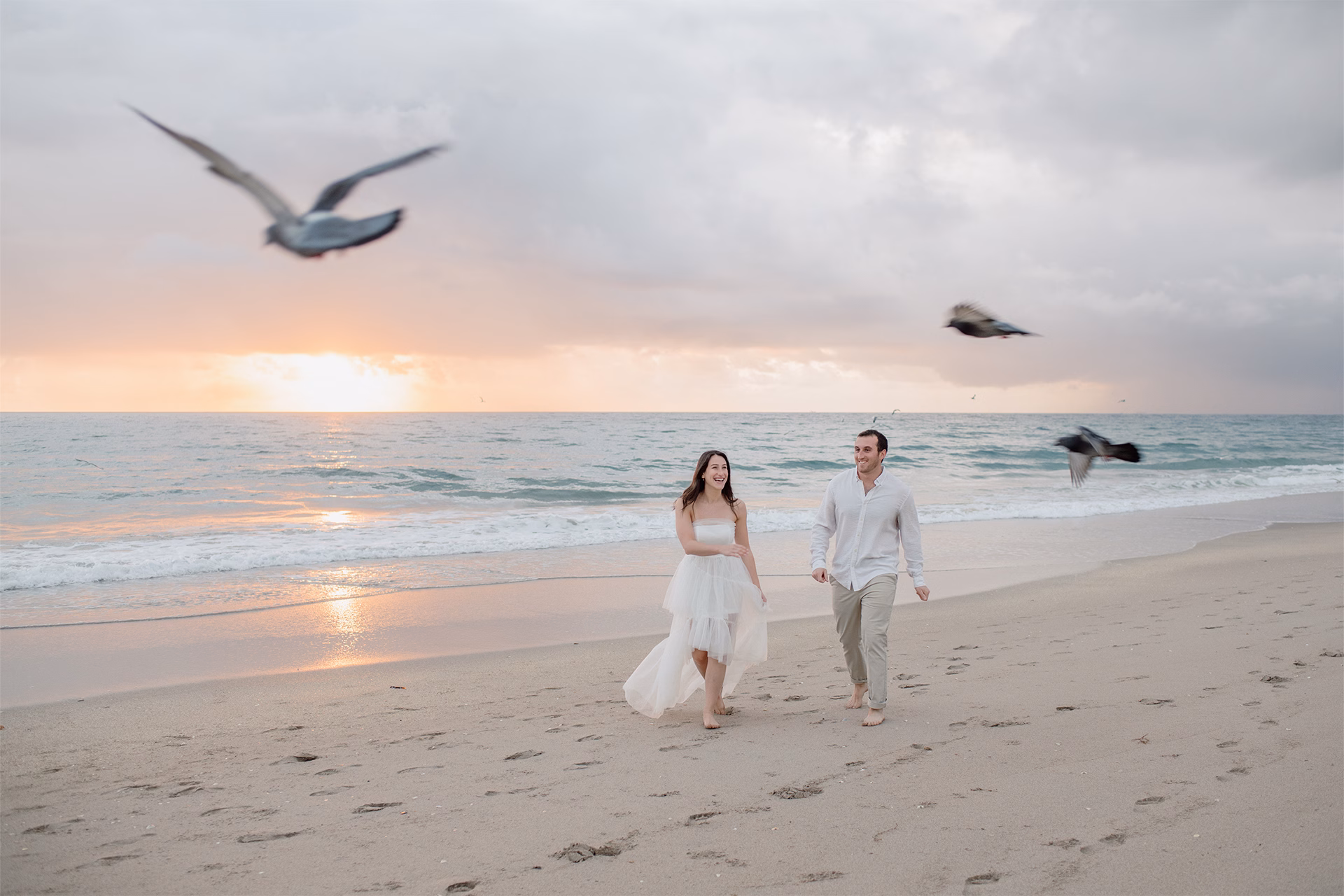Couple walking toward the camera at sunrise