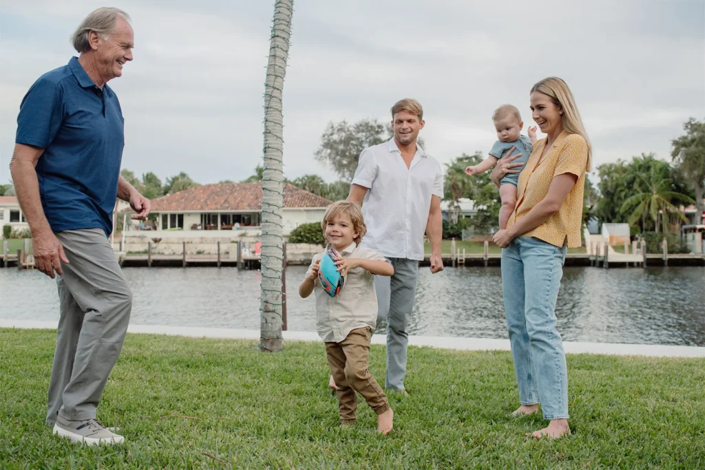 Candid photo of a family playing football during a family photo session in Fort Lauderdale