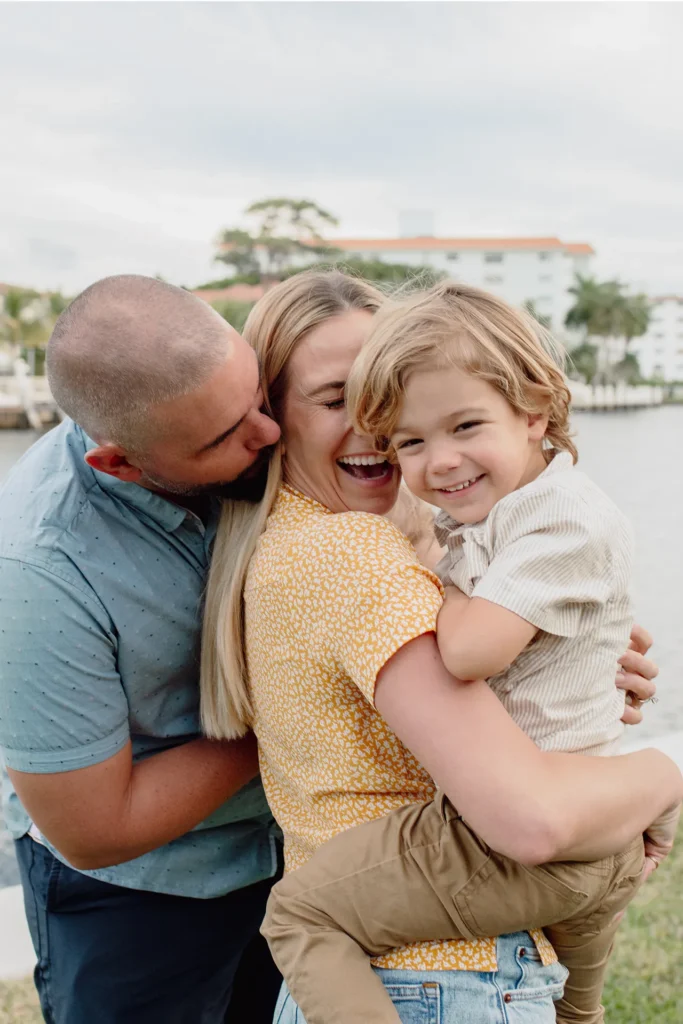 Mom, dad, and youngest son smiling during an At-Home Family Session in Fort Lauderdale