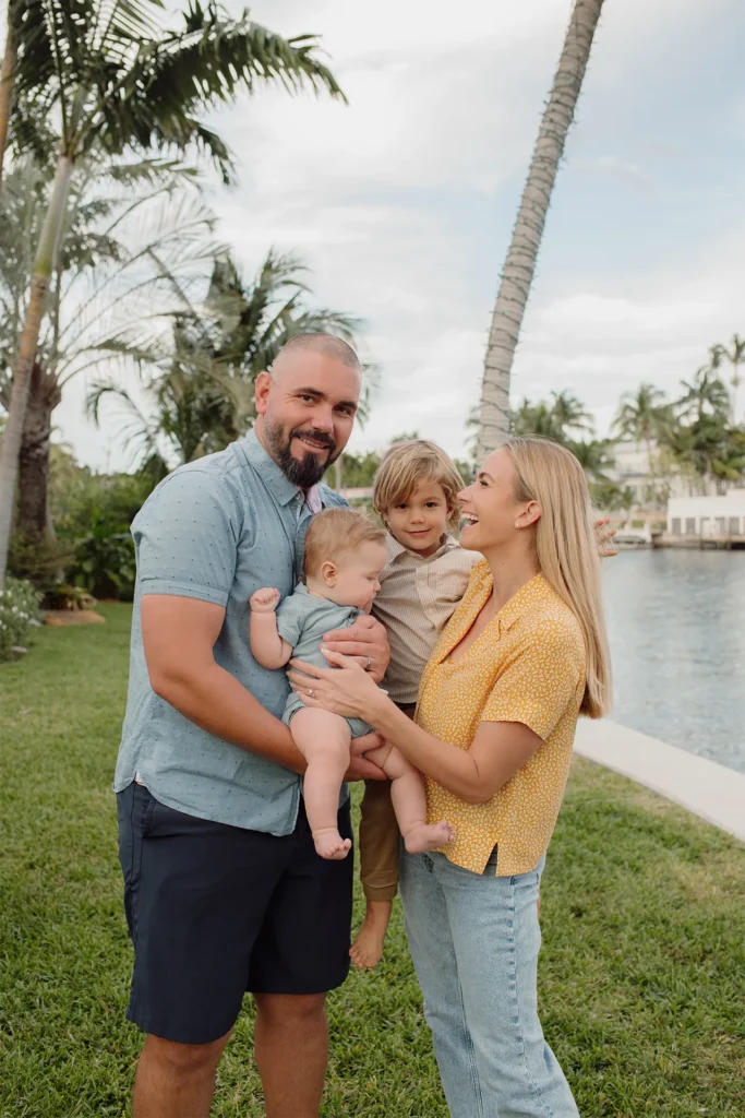 Photo of a happy family with two young sons during an outdoor family session in Fort Lauderdale