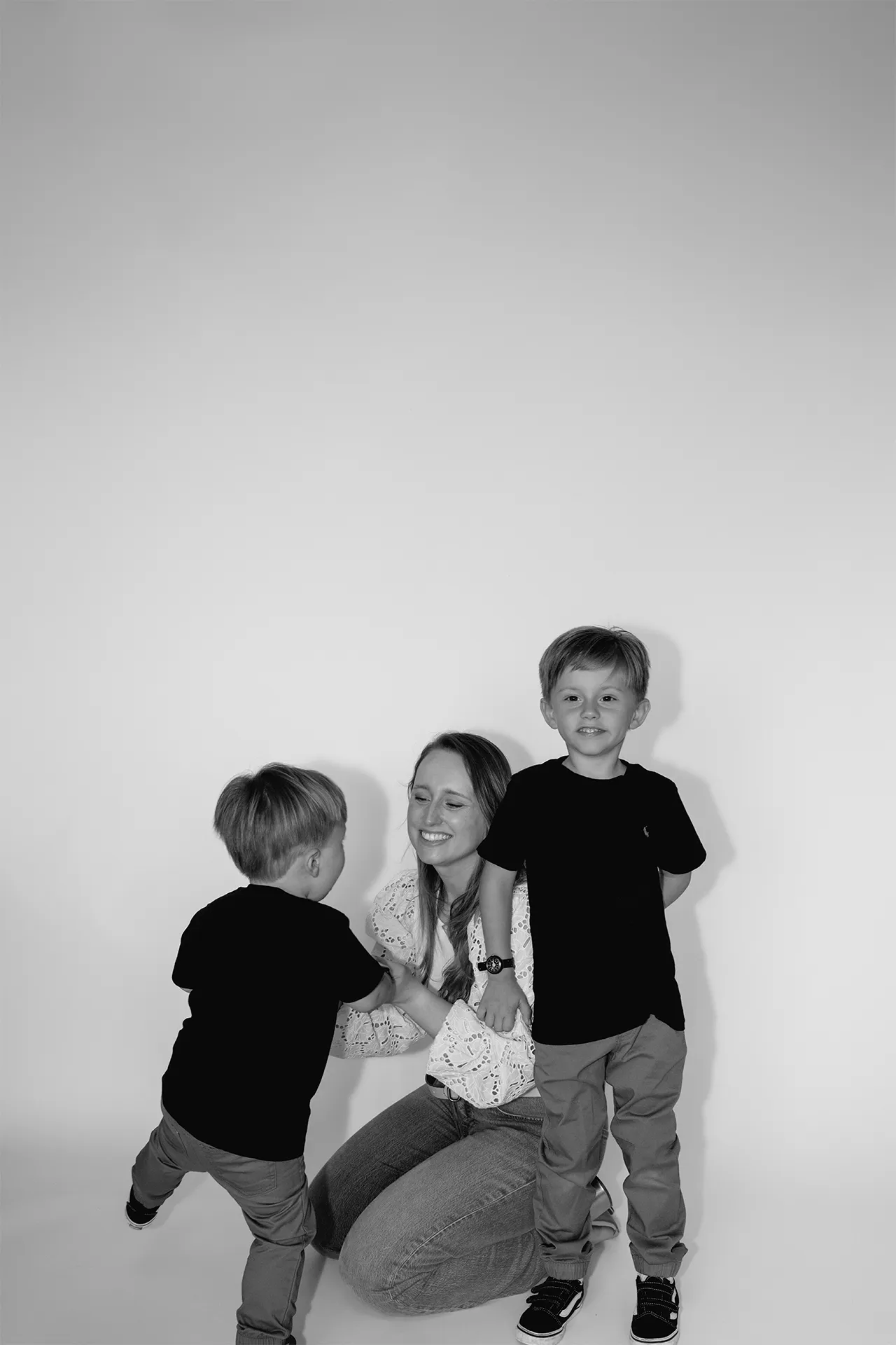 playful black and white photo with mom and kids