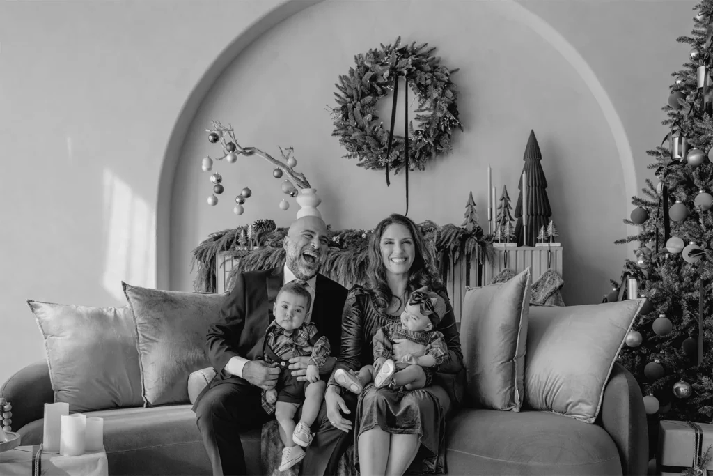 Black and white family portrait with holiday wreaths – Fort Lauderdale Holiday Mini Sessions