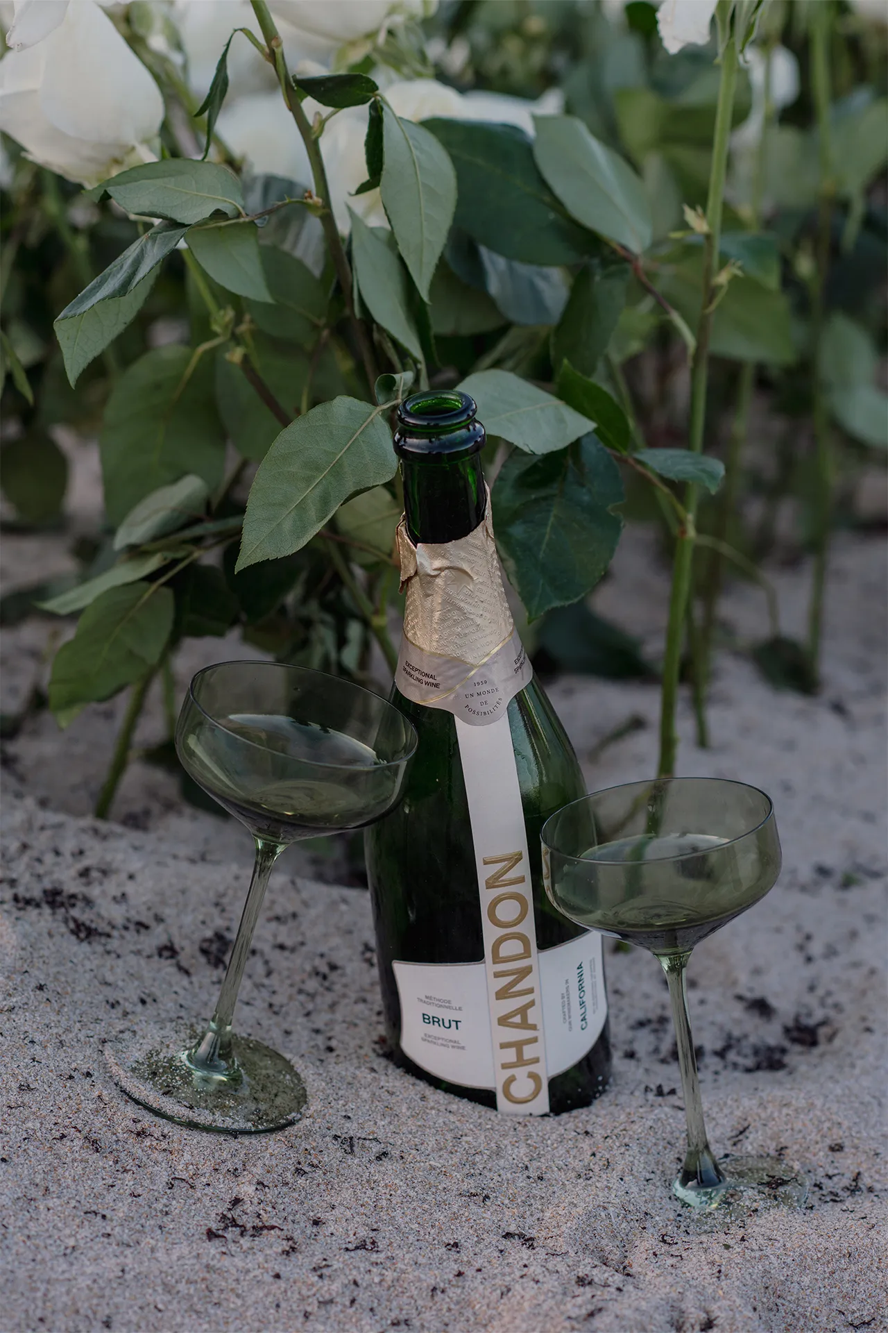 Closeup of champagne bottle and glasses ready for a celebratory proposal toast
