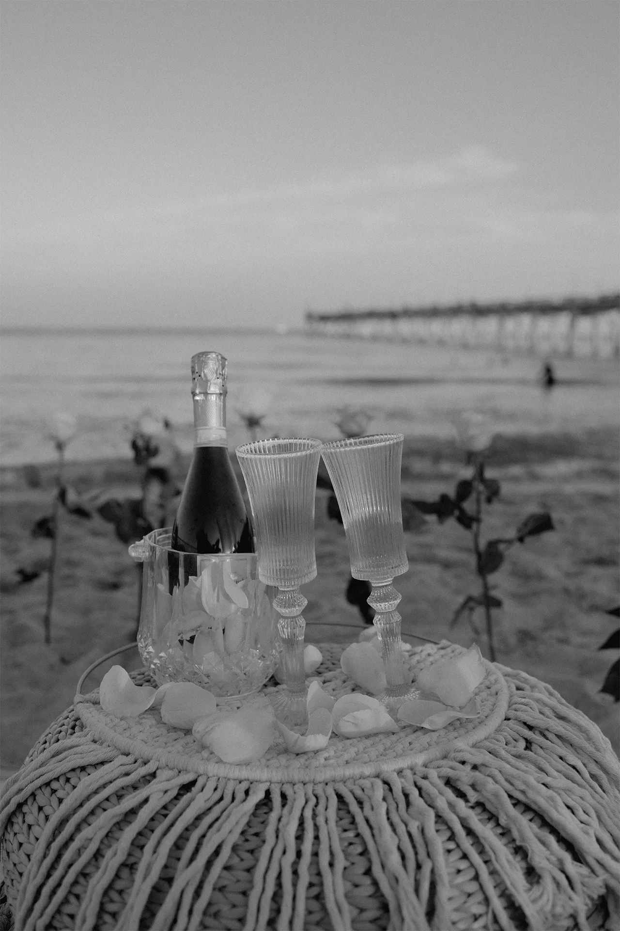 Black and white detail shot of the chilled champagne bottle ready for the toast