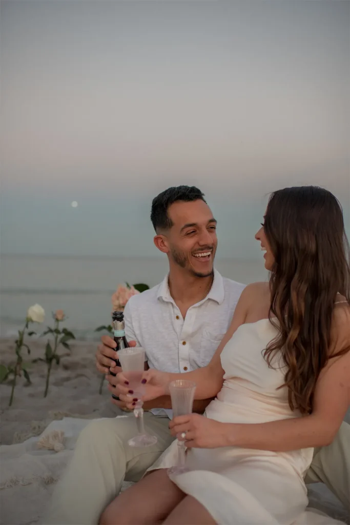 Vertical photo of the happy couple toasting with champagne glasses