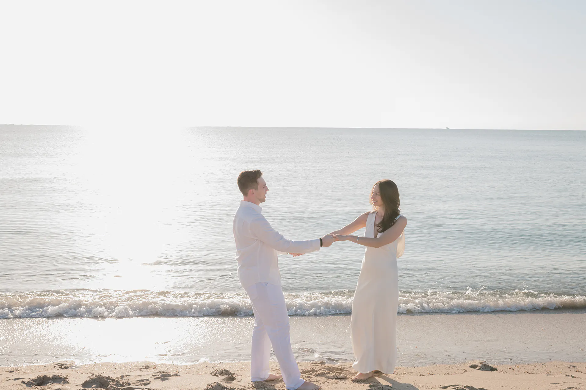 Hannah and Dylan dancing on the beach during their sunrise session in Lauderdale-by-the-Sea