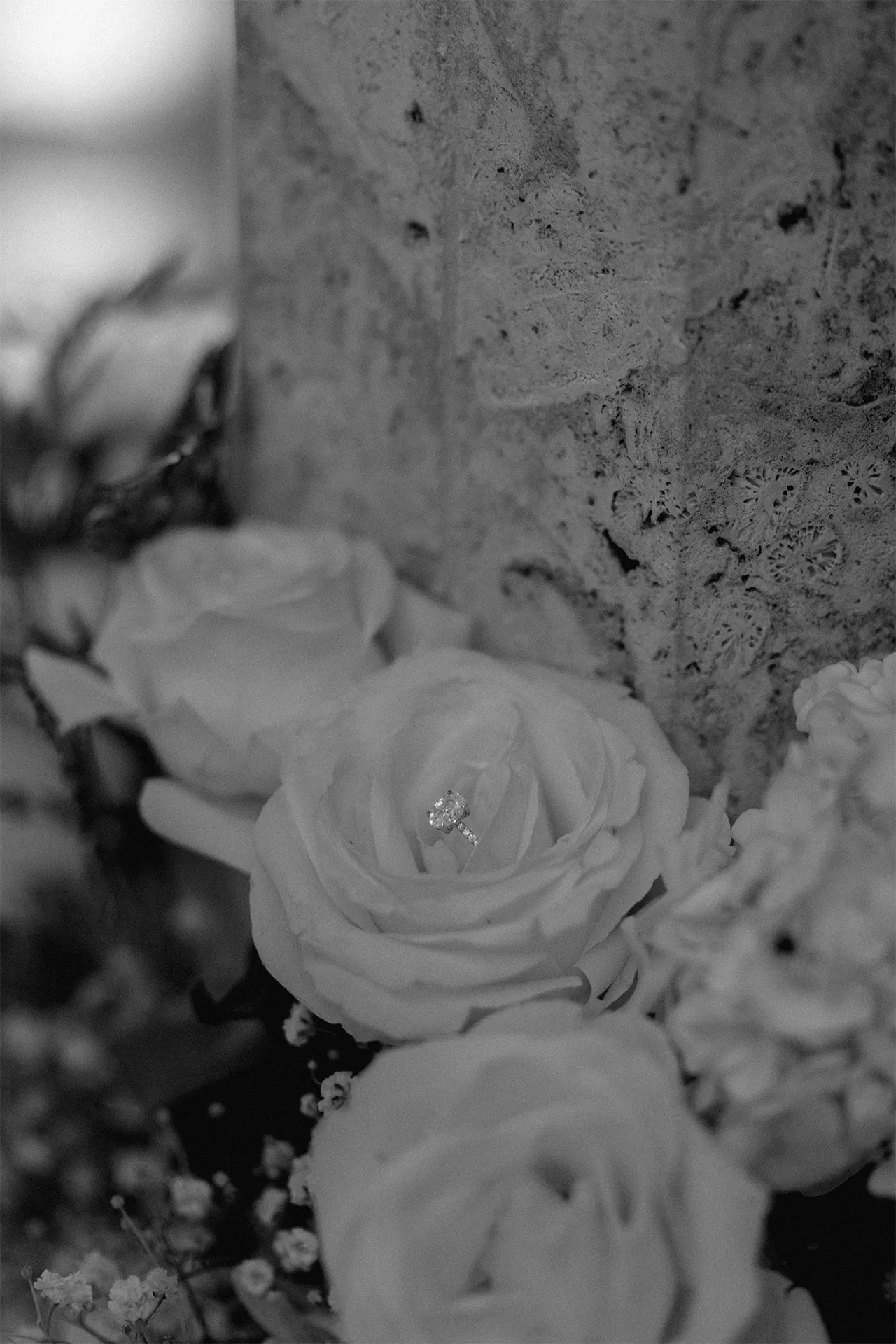 Close-up of the diamond engagement ring shining during a beachside proposal at sunset