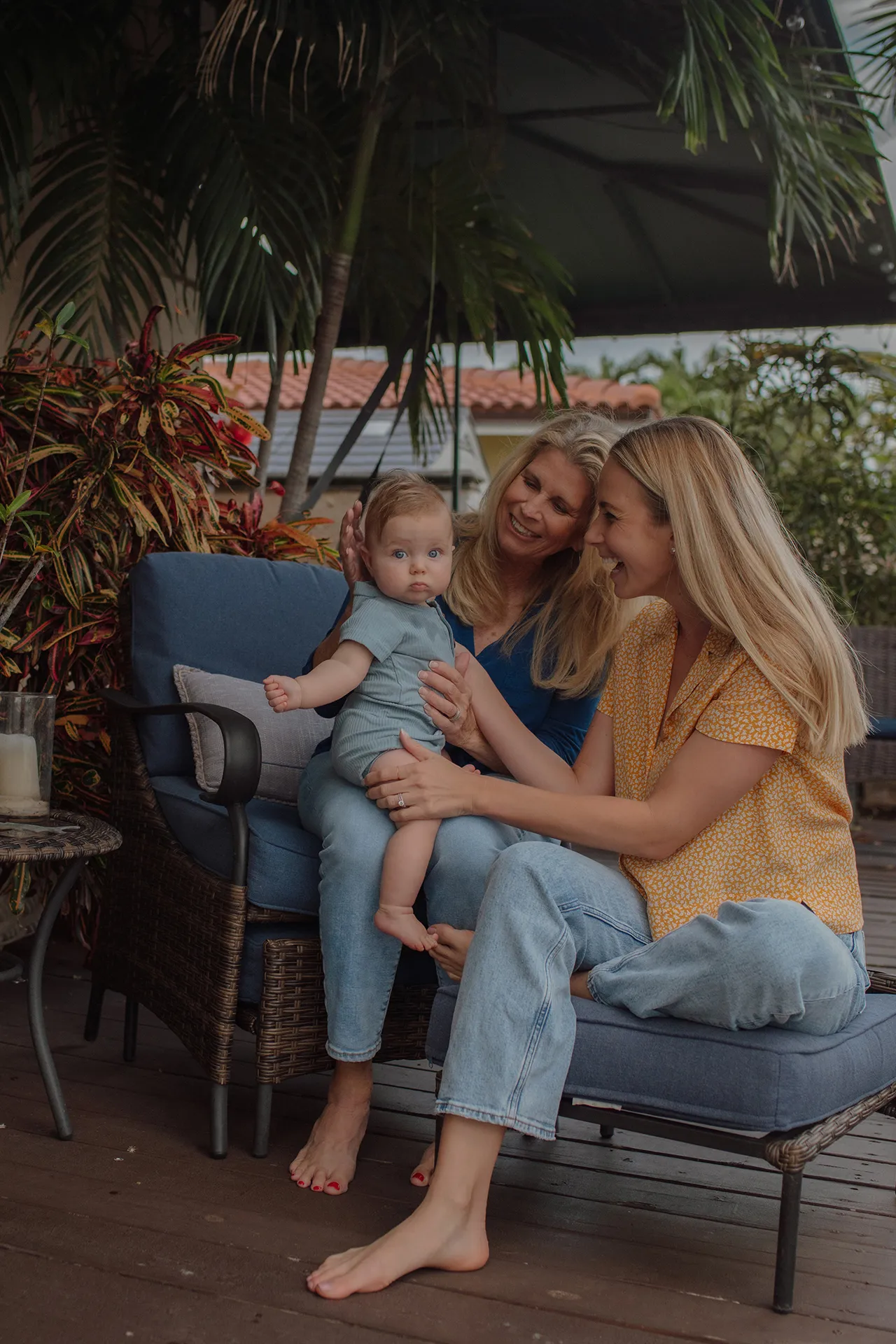 Grandmother, mom, and child posing for a Fort Lauderdale family photo.