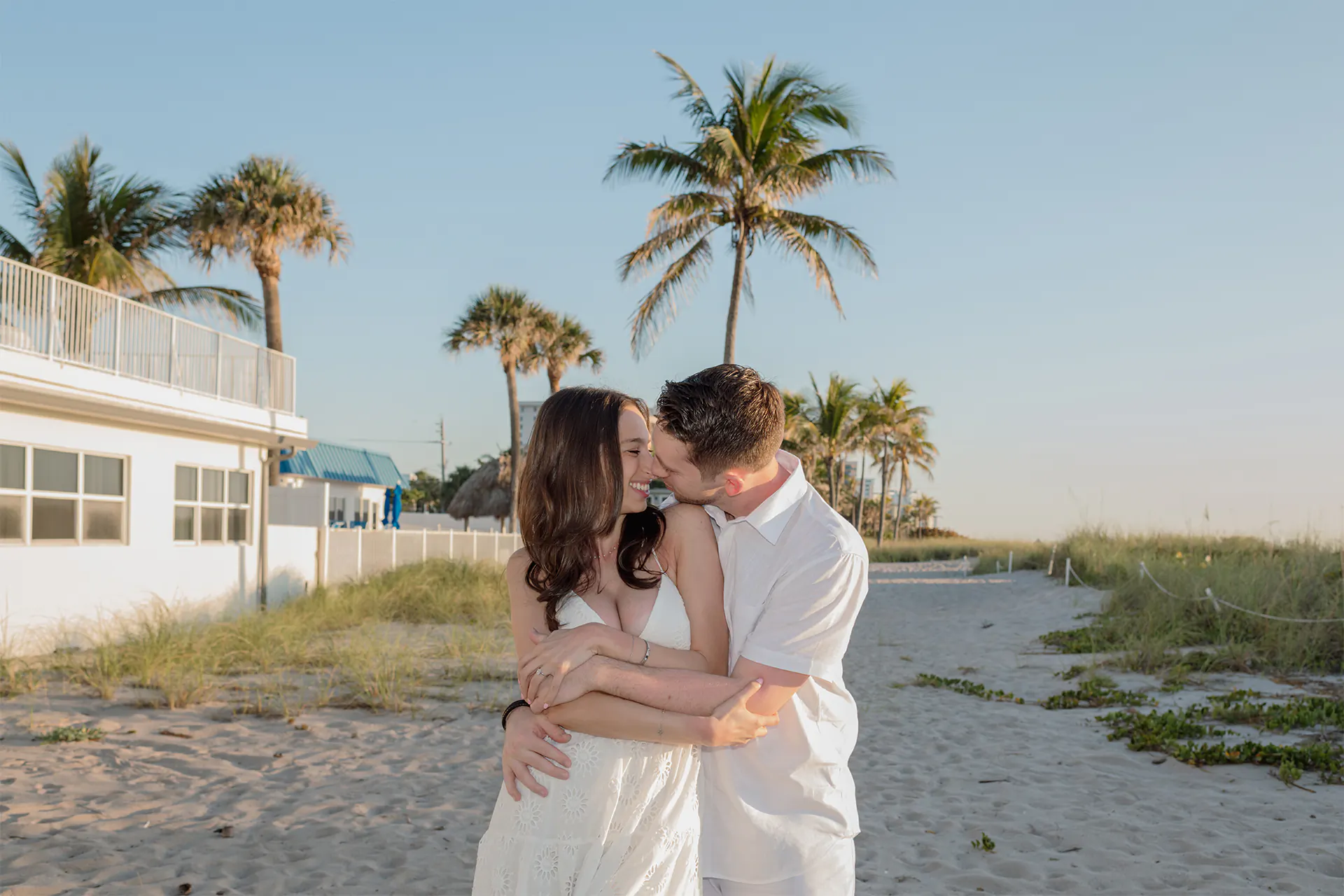 Hannah and Dylan hugging during their sunrise engagement session at El Prado Park