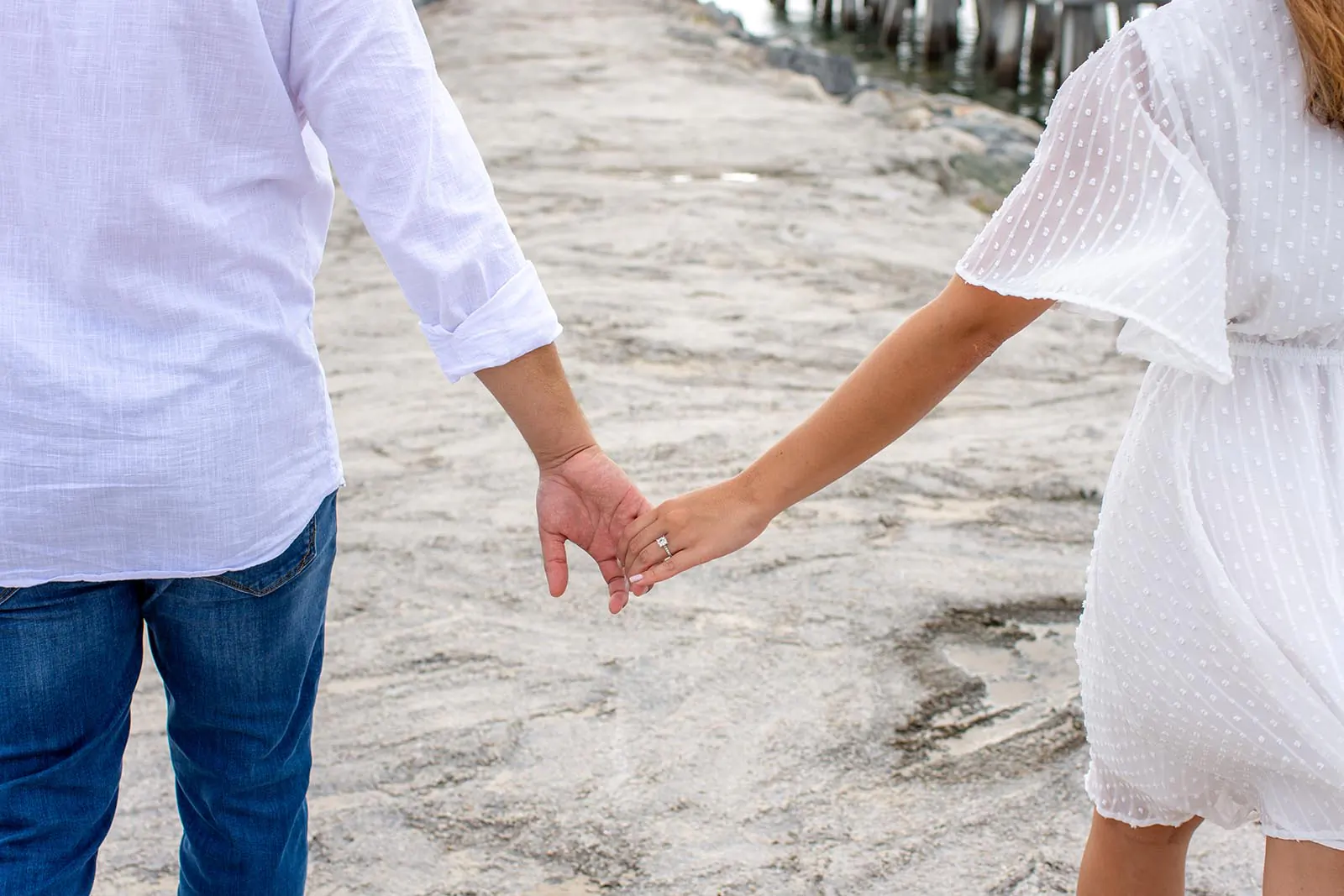 Closeup photo of couple holding hands during an engagement session