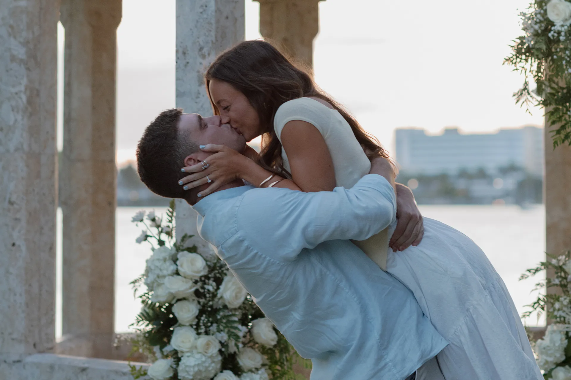 Fiancé lifting bride-to-be in a joyful embrace at their Bradley Park proposal in West Palm Beach