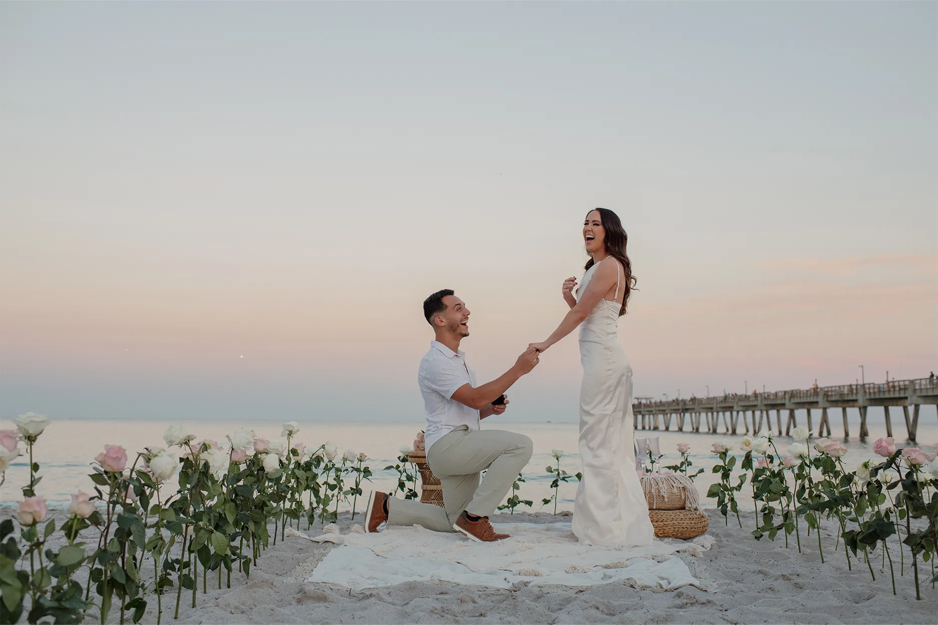 The defining moment: he kneels on the sand to propose at sunset in Dania Beach
