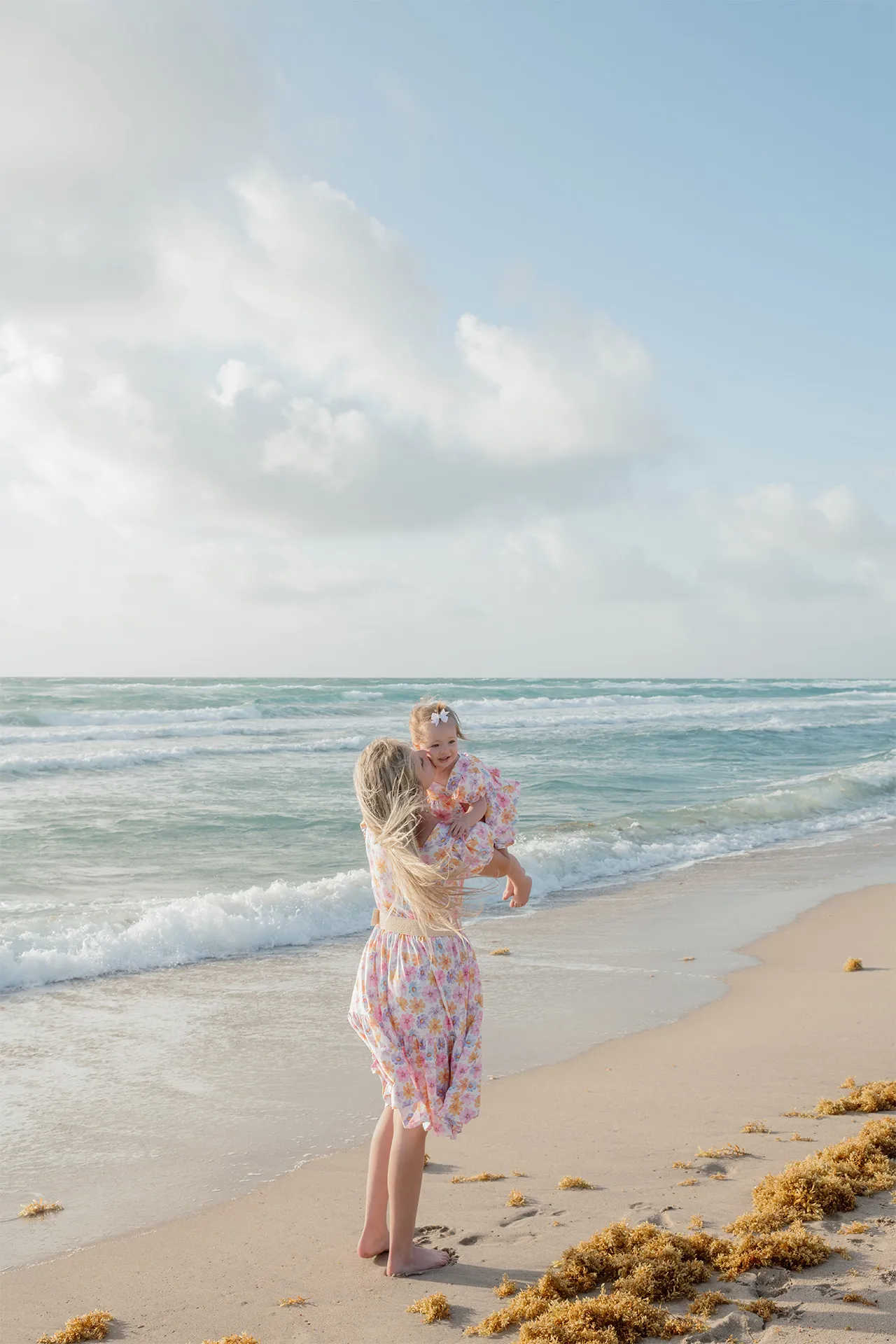 Light and airy lifestyle photo of a mom and daughter during a Delray Beach session.