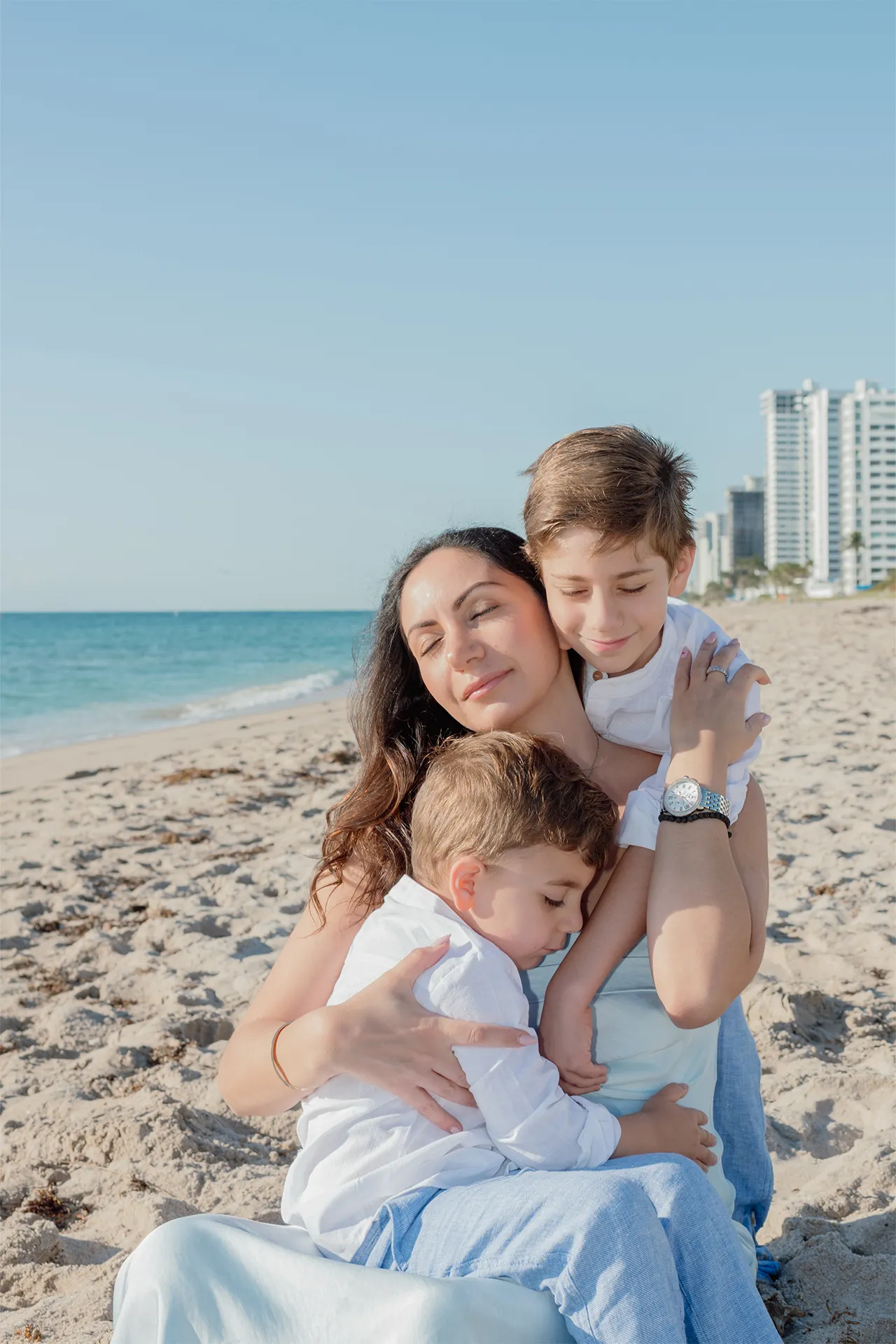 Professional portrait of a mother and her two sons at the beach in Lauderdale-by-the-Sea.
