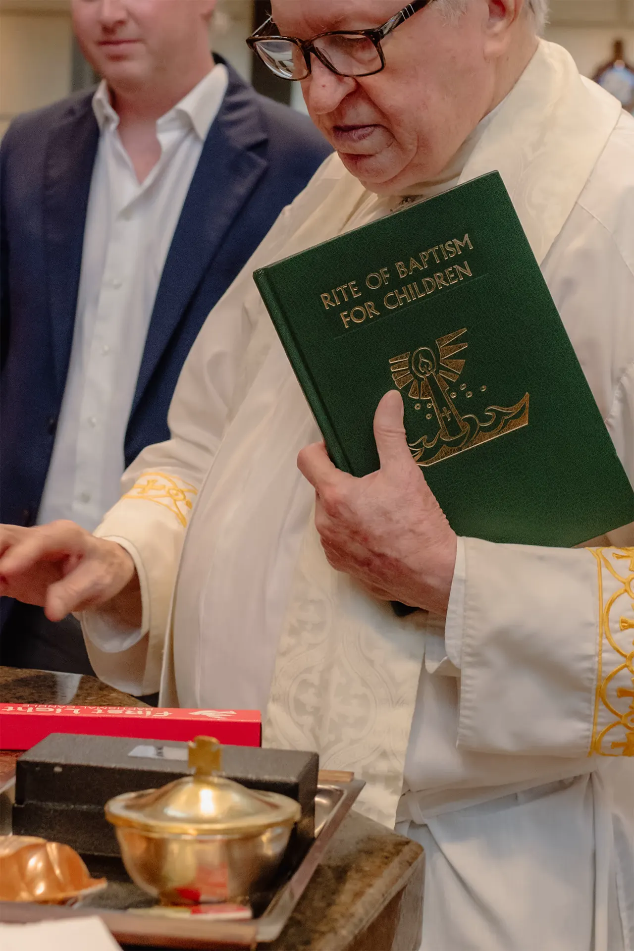 Closeup of a priest performing the baptism rite at Epiphany Church