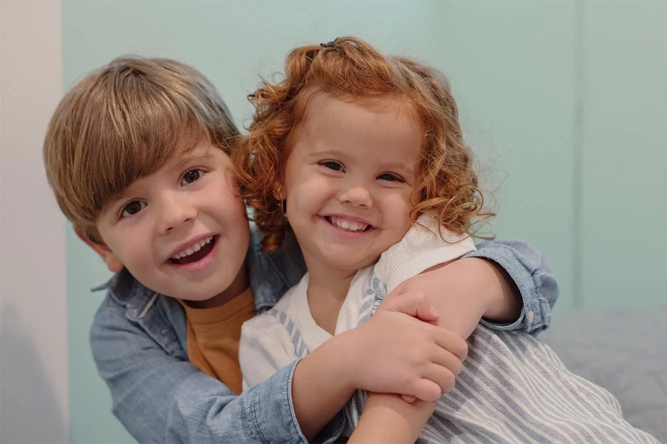 Portrait of two smiling siblings during a family photo session with Paula in Fort Lauderdale.