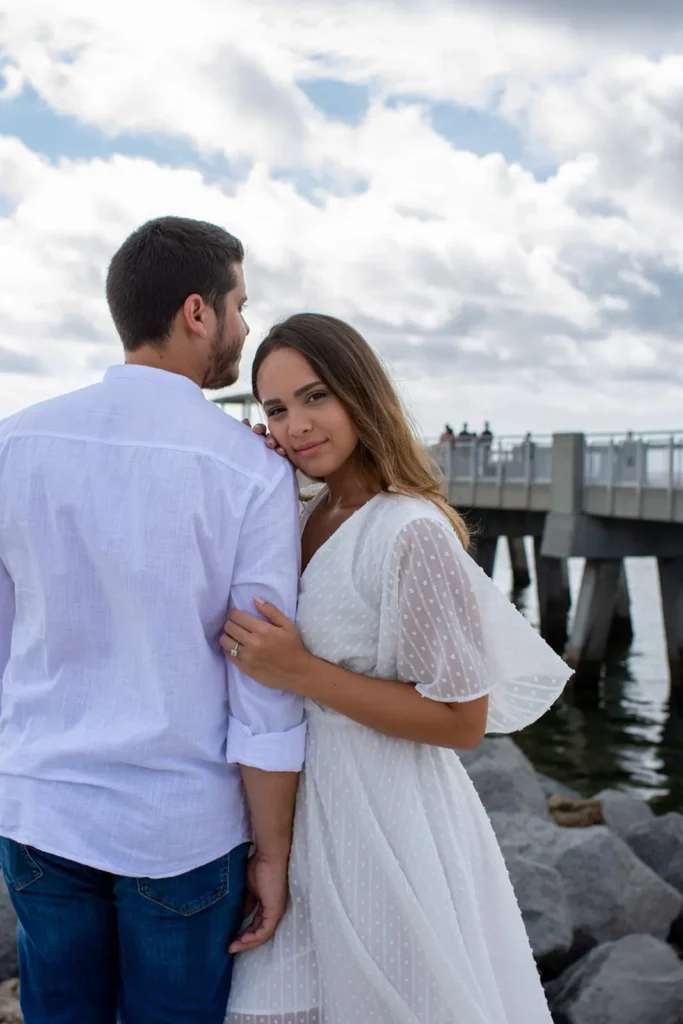 Vertical portrait of a young couple recently engaged in Miami Beach
