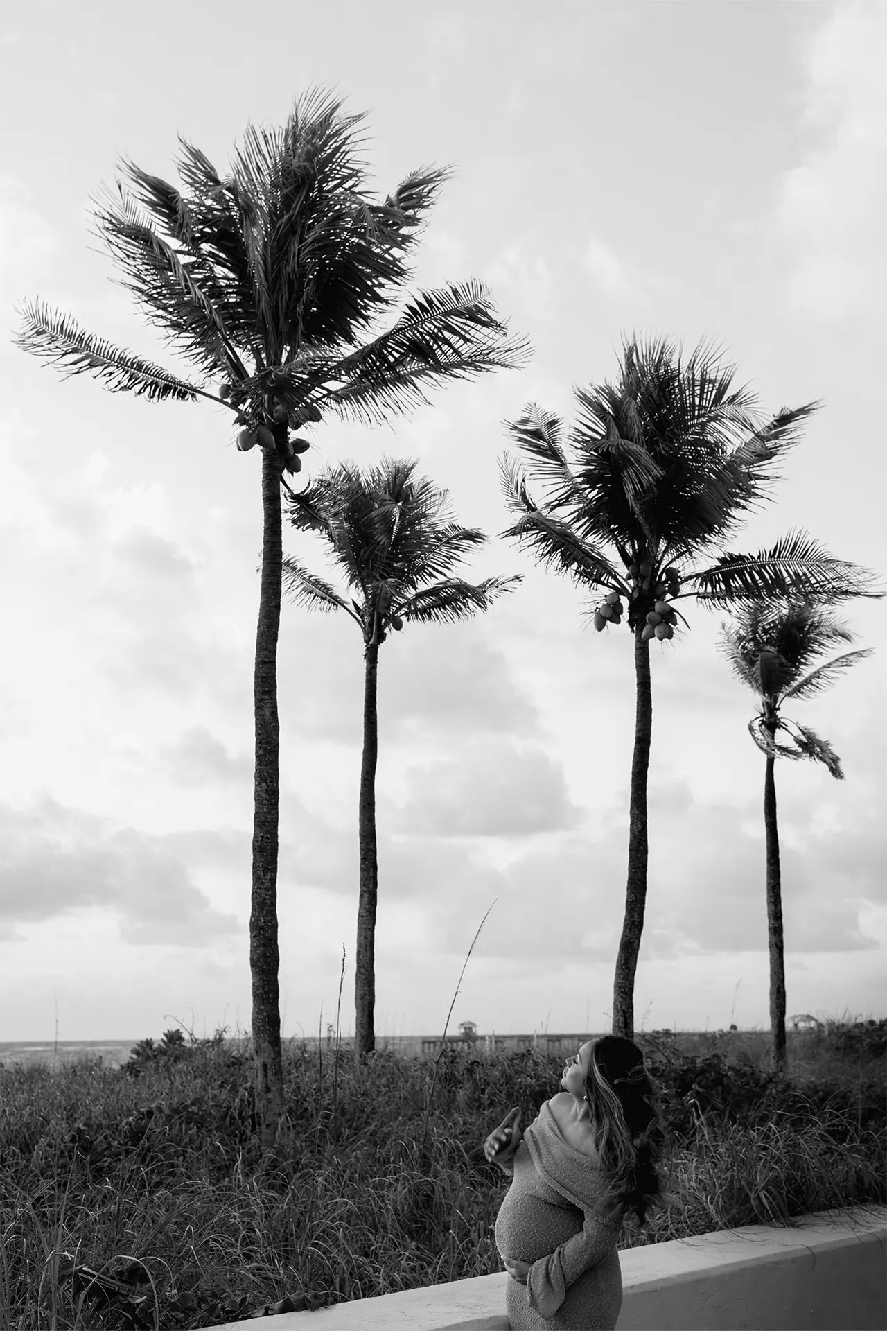 Artistic black and white maternity portrait capturing movement and emotion