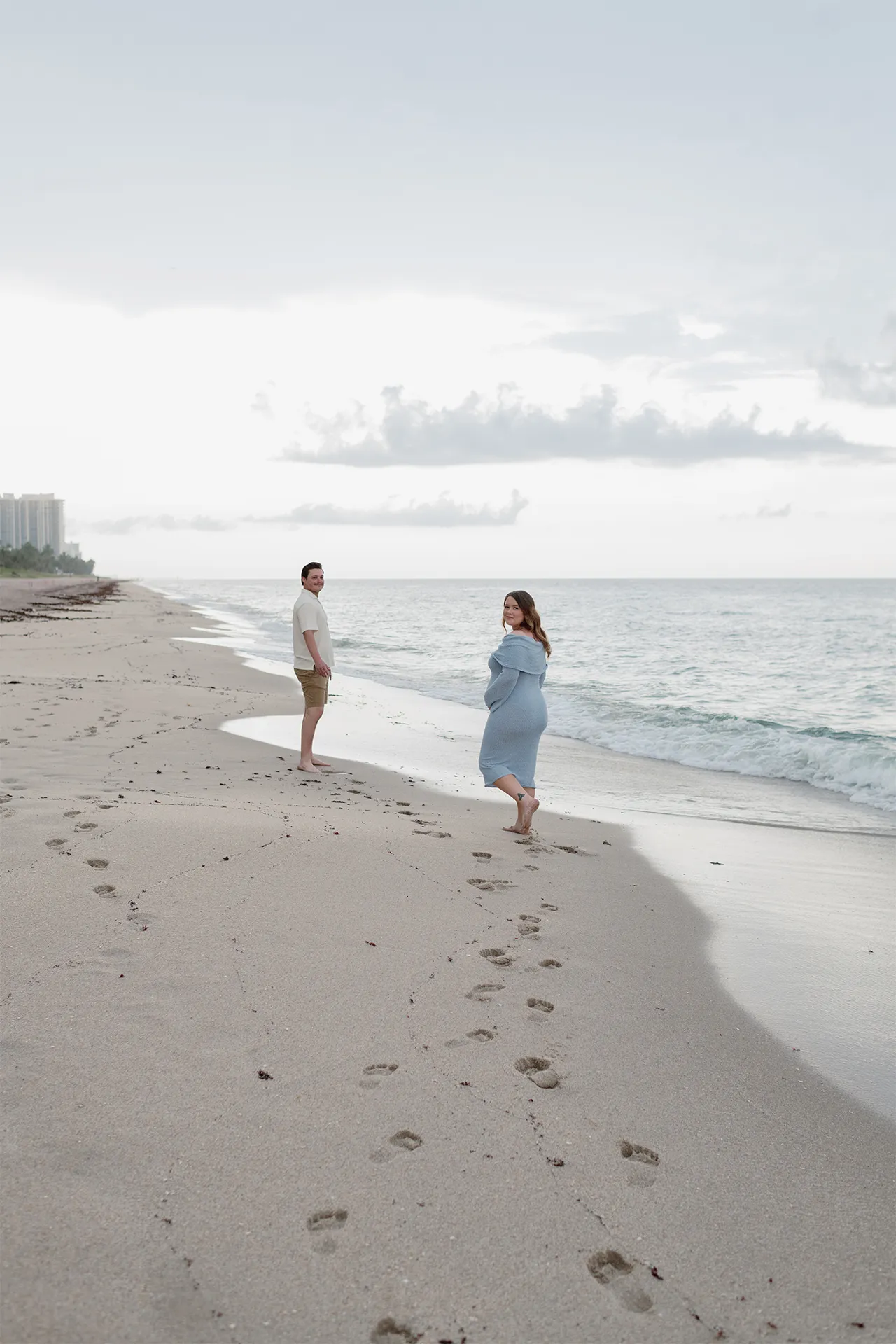 Expecting couple Chloe and Shawn walking along Fort Lauderdale beach during their babymoon