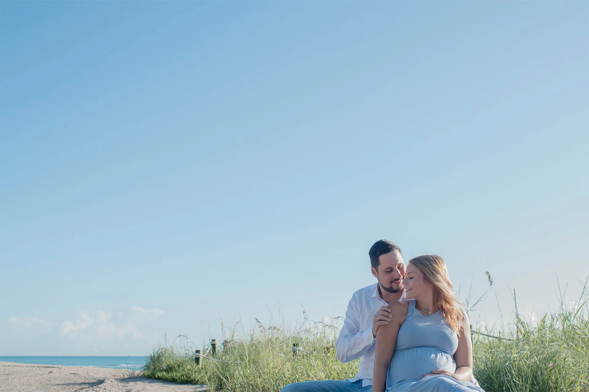 Professional maternity photographer in Dania Beach capturing an expecting couple at sunrise