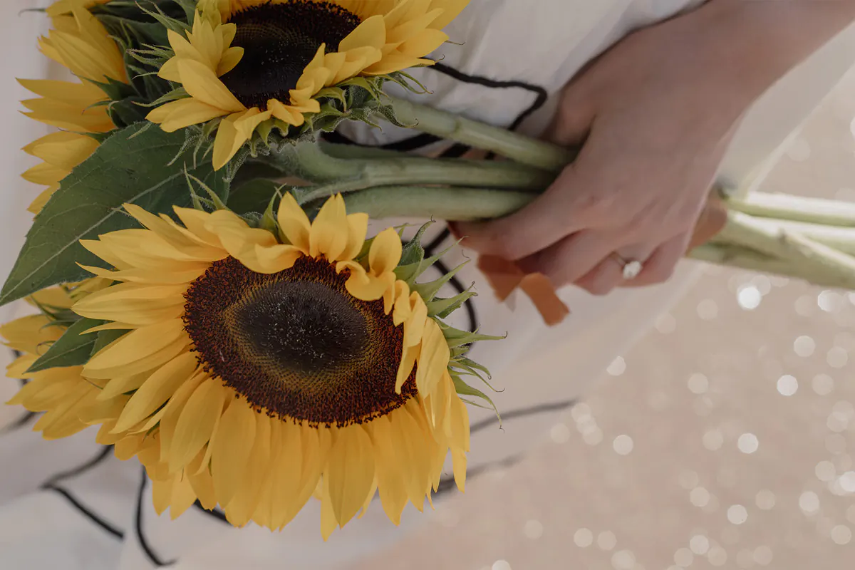 Close up image of a bride’s sunflowers and her engagement ring after a Fort Lauderdale proposal