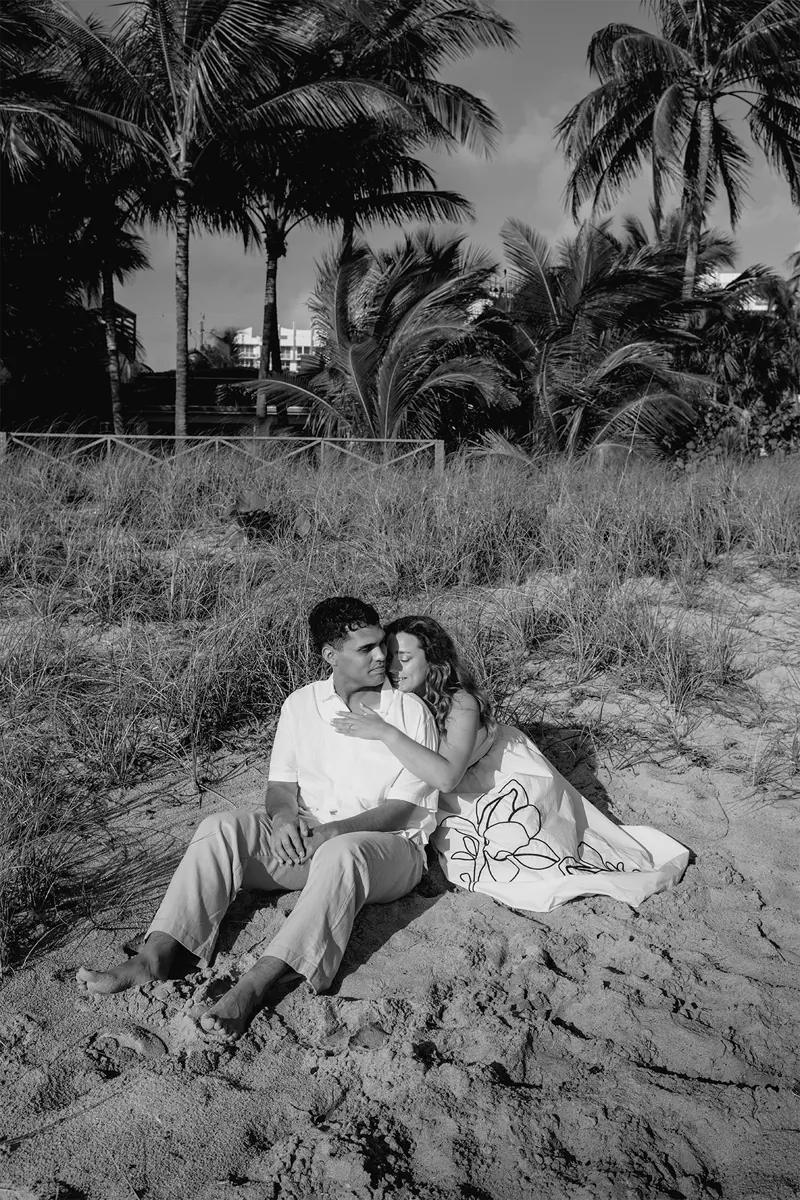 Black and white romantic portrait of a couple after their beach marriage proposal