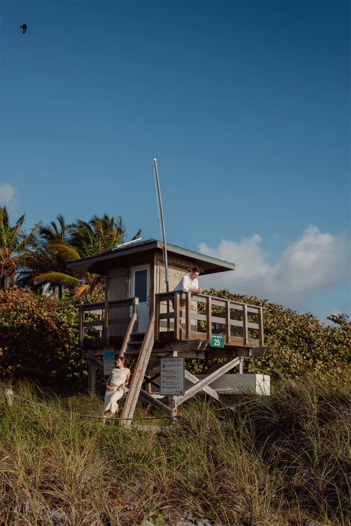 Boca Raton maternity photography session at South Inlet Park with lifeguard tower and clear blue sky